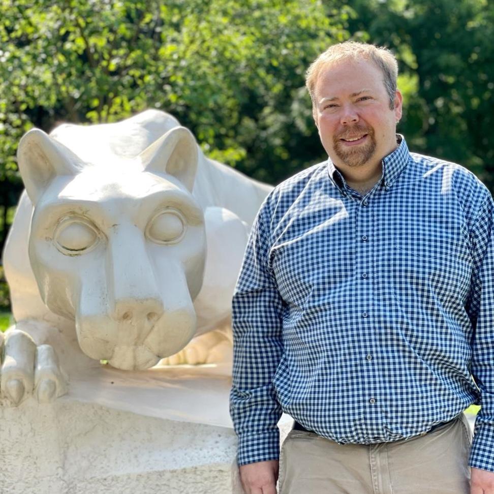 Doug standing in front of the Lion